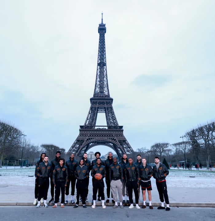 The Cleveland Cavaliers pose for a team photo in front of the Eiffel Tower in Paris, France.